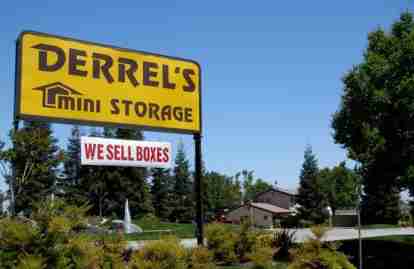 This image shows a Derrel's Mini Storage facility sign