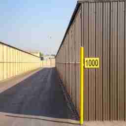 This image shows a row of outdoor storage units from end to end