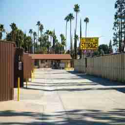 This image shows a yellow sign reading Derrel's Mini Storage above the outdoor units