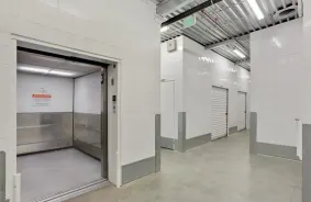 Open elevator door inside storage facility