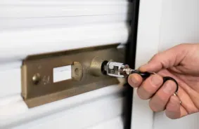 Opening a locked white roll-up storage door