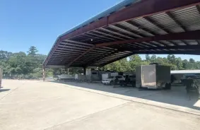 Vehicles parked under a canopy