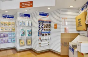 Displays of moving and packing supplies for sale, including packing peanuts, furniture bags, and tape.