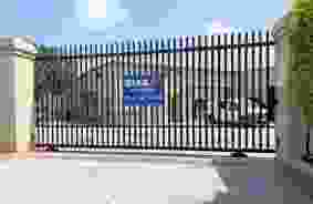 gated entrance with StaxUP Storage sign on gate