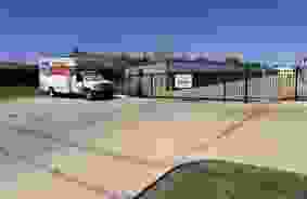 Front parking lot with a U-Haul truck in the background.
