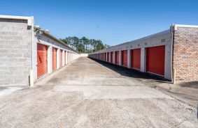 Drive way with Orange Storage Units with Roll Up Doors