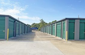 aisle of drive-up units with green doors