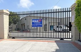 gated entrance with StaxUP Storage sign on gate