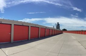 Wide shot of Storage Facility with a row of storage units on the left side if image