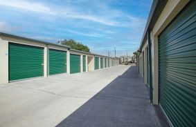 Exterior Drive-Up Units with green doors, angled from the right side of the aisle
