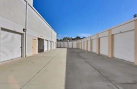 Drive up storage units in with white roll up doors