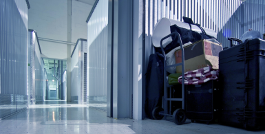 Hallway of storage units and a open storage unit that is full of stuff
