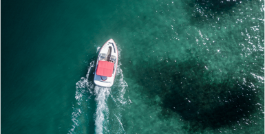 red boat on green blue water
