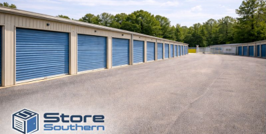 Drive-up storage units with blue doors at StoreSouthern, featuring wide drive aisles and a clean, well-maintained facility