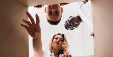 people looking and reaching inside of a storage box