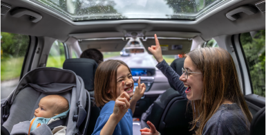 kids singing and baby in carseat in car