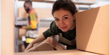 woman looking between storage boxes with friend