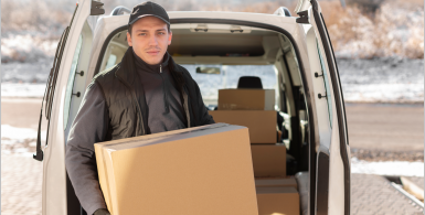 man with storage boxes by car doors