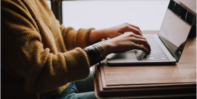 Person researching storage unit information online before renting