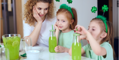 mom drinking green juice with kids