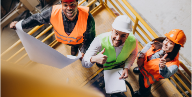 contractors looking upwards and smiling in orange and yellow vests
