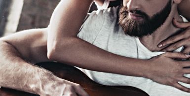 a young couple sitting together, the man is playing guitar