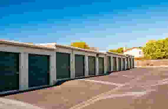 A row of exterior drive-up storage units.