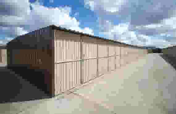 This image shows a row of outdoor storage units from end to end