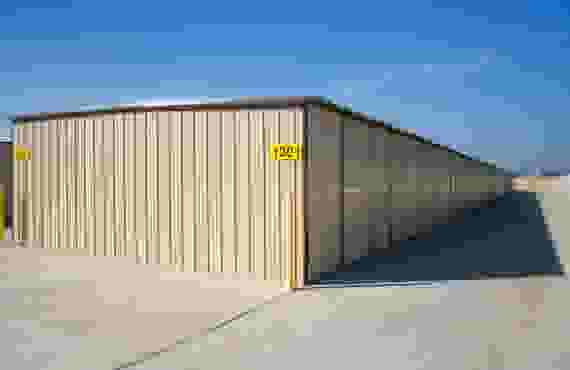 This image shows a row of outdoor storage units from end to end