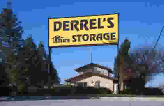 This image shows a yellow sign reading Derrel's Mini Storage