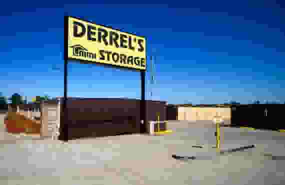 This image shows a yellow sign reading Derrel's Mini Storage