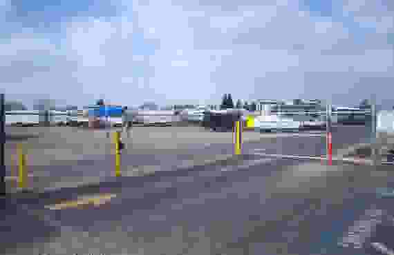 This image shows the fence surrounding our storage facility as well as 4 rows of RV storage spots in use