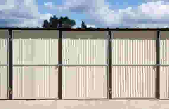 This picture is of outdoor storage units lined up next to each other