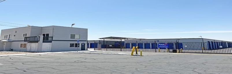 The front of the property. Storage unit buildings sit behind a fence