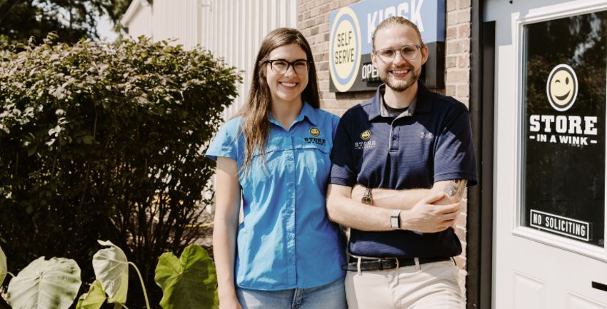 The two owners of Store In A Wink standing in front of their office entrance