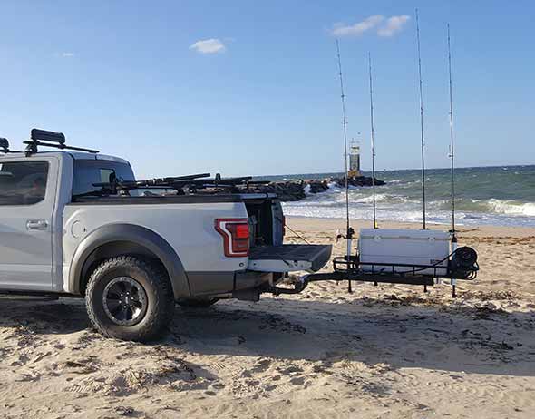 Ford pickup truck on the beach with StowAway Surf Fishing Rod Rack