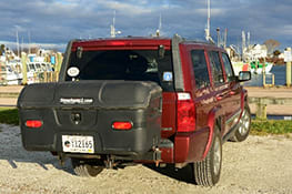 Stowaway cargo carrier on red Jeep on sand