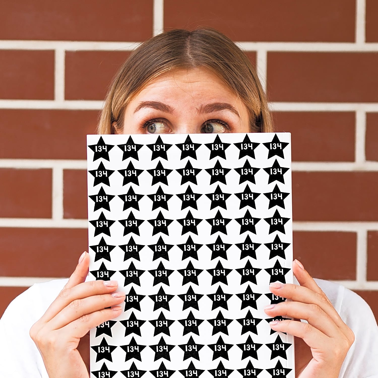 Size markers with black stars and number 134, held by a person