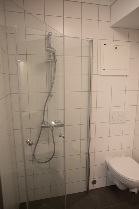 Shower in bathroom at Kårstua, Klokkergården Student Housing in Vestfold