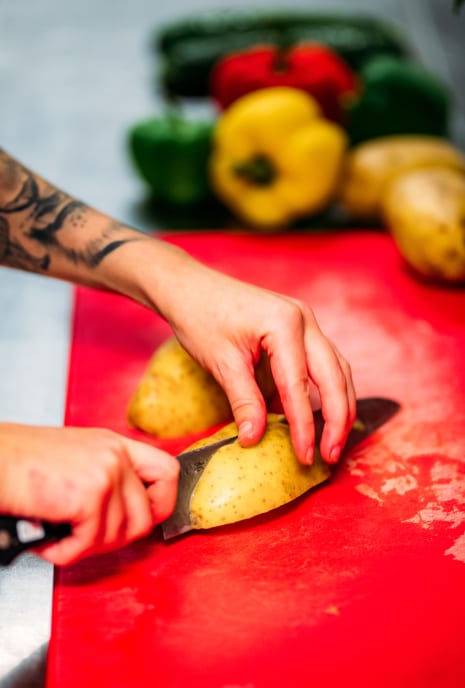 Chef cutting potatoes