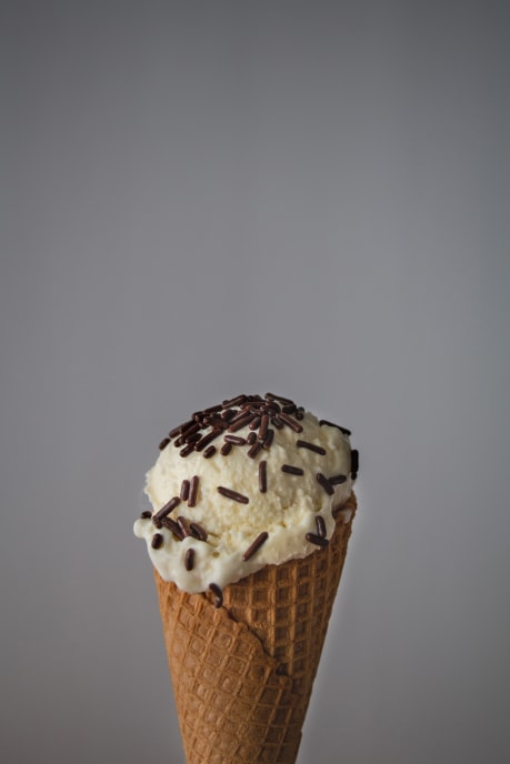 Ice cream scoop in a cone with chocolate sprinkles