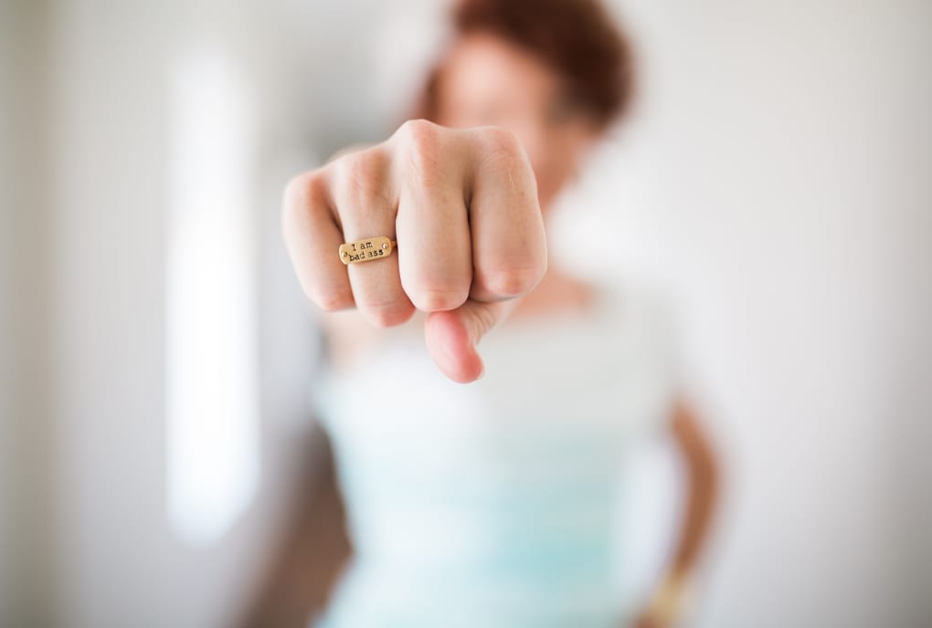 Girl wearing I am bad ass ring