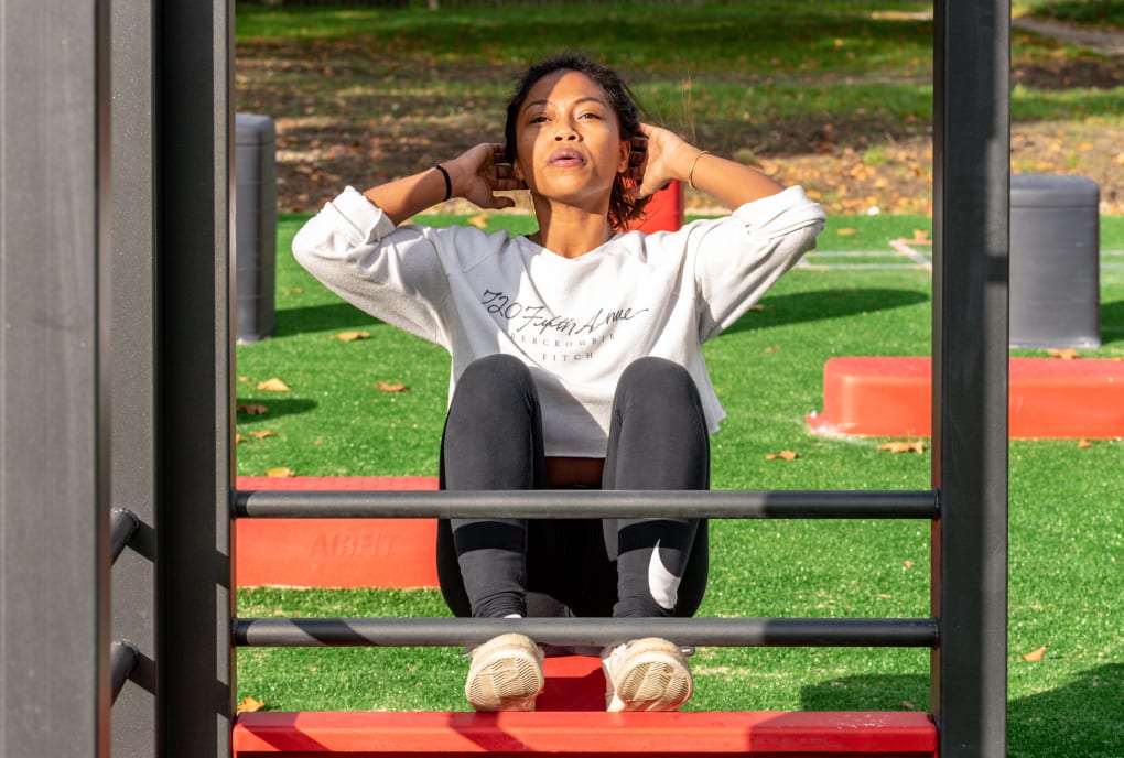 Girl doing situps in a park