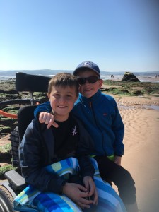 George, who has DMD, with his brother at the beach