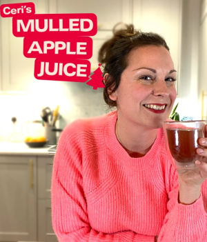 Chef holding glass of mulled apple juice