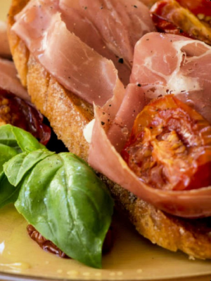 Ham on toast with tomatoes and fresh basil