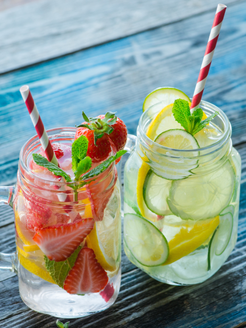 Jars of water with fruit and straws