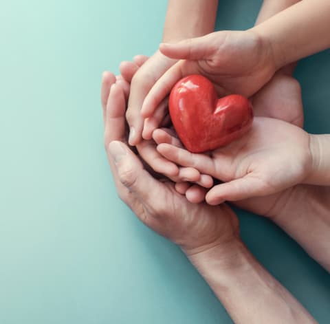 Hands holding a ceramic heart