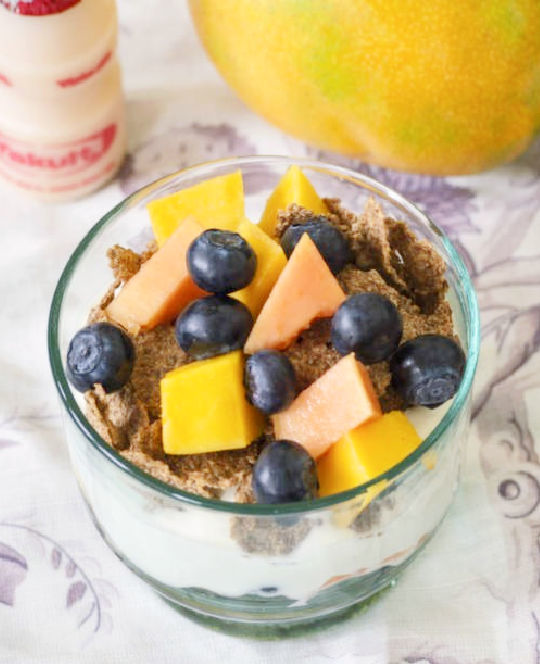 Bowl of cereal with fruit and Yakult Original