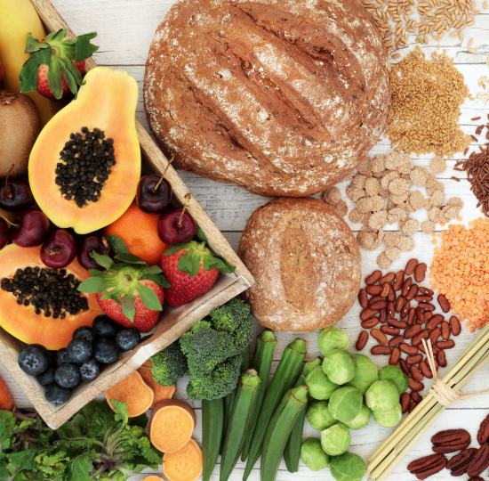 Wholegrain loaf of bread, fruits, nuts, pulses and vegetables